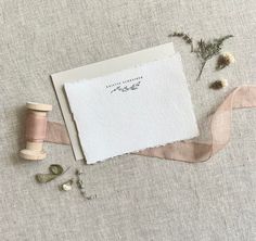 some spools of thread are next to a piece of paper