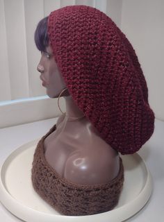 a mannequin head wearing a red knitted hat