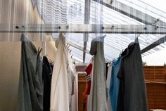 clothes are hanging up in an enclosed area