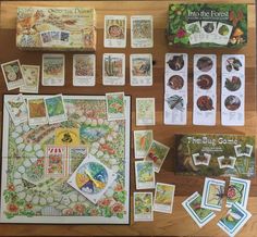 an assortment of cards and games laid out on a wooden table next to each other