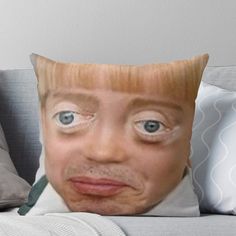 a close up of a person's face with blue eyes on a couch throw pillow