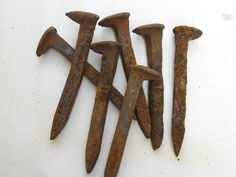 several rusty nails are arranged in the shape of letters