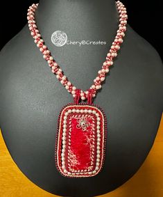 Introducing the stunning Pearl Swirl Necklace, a one-of-a-kind piece of jewelry that is sure to turn heads. Soft pink pearls, red beads and rhinestone chain accent a large red Magnesite pendant, measuring 3" inches long and 2" wide. The red beads and pearls swirl in a beaded rope that measures 16". Two 2" extender chains add up to 4" of length. Swirl Necklace, Stained Glass Earrings, Marble Necklace, Donuts Earrings, Abalone Earrings, Dazzling Earrings, Beaded Art, Pink Pearls, Rhinestone Chain