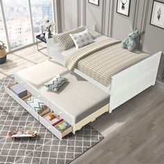 a white bed sitting on top of a wooden floor