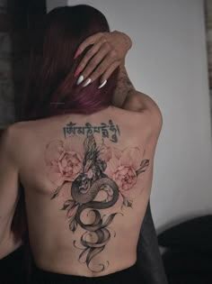 a woman with a dragon tattoo on her back