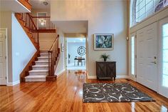 a living room with hard wood floors and white walls on the second floor is shown