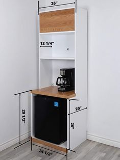 a white shelf with measurements for the space between it and a black refrigerator freezer