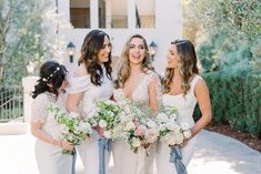 the bride and her four bridesmaids are all dressed in white