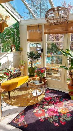 a sun room with lots of plants in it