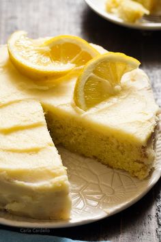 a slice of lemon cake on a plate with two slices cut out and ready to be eaten