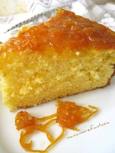 a piece of cake sitting on top of a white plate next to an orange peel