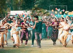 a group of people dancing in front of a crowd