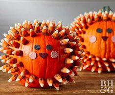 two pumpkins decorated like hedgehogs sitting on a table