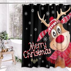 a shower curtain with a reindeer wearing a red hat and scarf on it's head