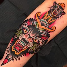 a tattoo with an image of a cat and a demon on it's arm