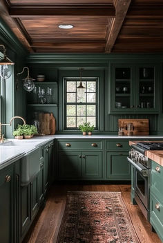 a kitchen with green cabinets and wooden floors, along with a rug on the floor