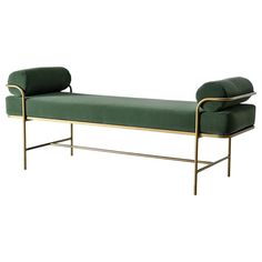 a green velvet bench with gold frame