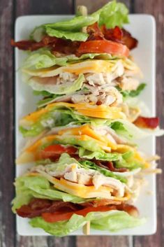 chicken, lettuce and tomato salad on a white platter with toothpicks