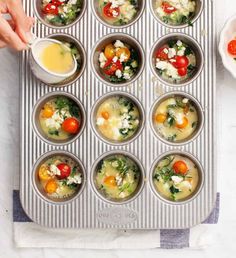 the muffin tins are filled with different types of food