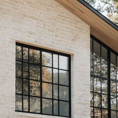 a white brick building with black windows on the side