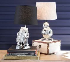 a lamp that is sitting on top of a table next to a book and some books