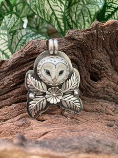 "Peaceful owl sits peacefully amongst a flower and ferns watching the world and camouflaged by the greenery. The original was recently sold but I will make a limited number of these on a made to order basis. L: including bail 1.75\" W: 1.3\" 16.1 g total weight All the silver is solid sterling.   The owl face is a hand painted, porcelain clay owl which was made by Lana Manna in the Czech Republic.  The owls I use are incredibly detailed and the porcelain is fired at a high temperature making it Owl Jewelry Necklace, Owl Face, Owl Designs, Clay Owl, Soldered Jewelry, Metalsmithing Jewelry, Owl Earrings, Precious Metal Clay, Owl Jewelry