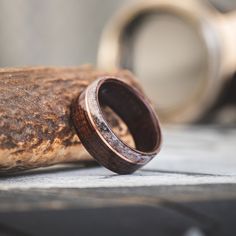 a wooden ring sitting on top of a piece of wood