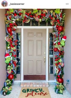 the front door is decorated for christmas with candy canes and wreaths on it