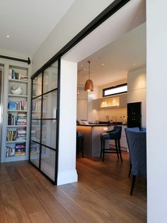 an open living room and kitchen area with sliding glass doors leading to the dining room