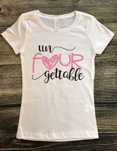 a white t - shirt with the words un four gettablee written on it