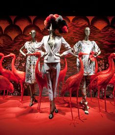 mannequins dressed in white and red with flamingos behind them