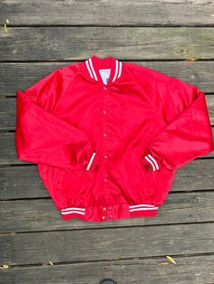 Vintage 80s red satin bomber style athletic sports jacket by Auburn Sportswear. Snaps down the front and has two front pockets. Would be perfect to add patches or iron decals too! Marked a size XL, see measurements below. In good condition overall but does have a stain on the cuff of sleeve and also has a couple other marks (see photos)  Measurements: P2P/ 24.5" Sleeve length/ 31.5" Length/ 28.5" *Please make sure to check photos, measurements and description prior to purchasing. Feel free to message me with any questions. Style Athletic, Athletic Sports, Red Satin, Athletic Fashion, Sports Jacket, Auburn, Mens Jackets, Overalls, Bomber Jacket