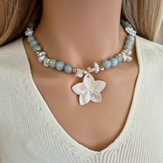 Introducing our stunning aquamarine necklace with mother of pearl big flower pendant & keshi pearls, the perfect Natural Aquamarine Gemstone Necklace seeking a touch of luxury in your aquamarine jewelry collection. This Beaded Aquamarine Choker is not just a piece of jewelry, but a work of art that will surely make heads turn. This  blue floral necklace is the ultimate gift for her, a loved one, or a nature lover who appreciates the beauty of the sea. Perfect for summer beach parties or any spec Luxury Handmade Beaded Necklaces With Mother Of Pearl, Luxury Mother Of Pearl Beaded Necklace For Gift, Baroque Jewelry, Pearl Drop Necklace, Pearl Jewels, Beach Parties, Aquamarine Necklace, Aquamarine Jewelry, Keshi Pearls