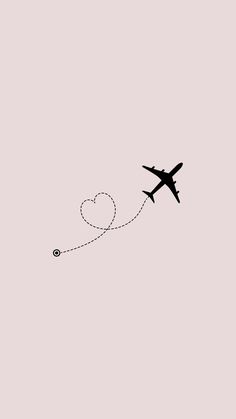 an airplane is flying in the sky with a heart