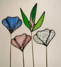 three stained glass flowers sitting next to each other