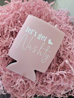 a pink vase filled with pink shredded paper and a sign that says let's get mashty