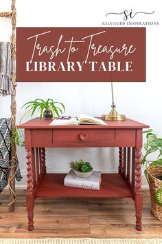 a red table with books and plants on it in front of a sign that says fresh to treasure library table