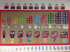 a bulletin board with lots of handprints on it and numbers in the middle