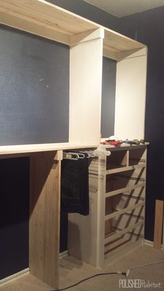 an unfinished room with blue walls and white cabinets