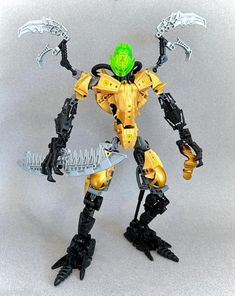 a yellow and black robot with green eyes holding a knife in one hand while standing on a gray surface