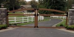 a gated driveway leading to a house