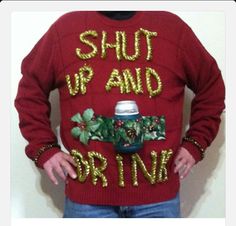 a man wearing a red sweater with the words shut up and drink written on it