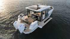 a white boat floating on top of a body of water