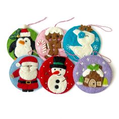 six christmas ornaments are hanging on a white background with snowman, santa clause and other holiday decorations