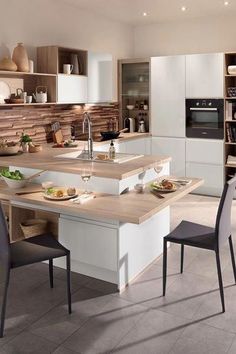 a kitchen with an island and chairs in it