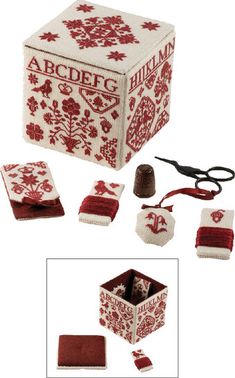 a red and white knitted box with scissors