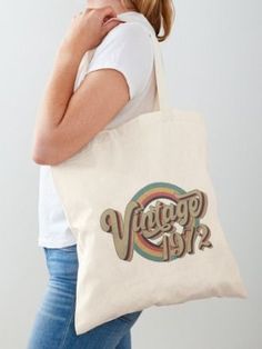 a woman carrying a tote bag with the words, vintage 1950's on it