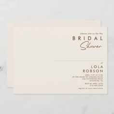 a white business card with the words bridal shaver on it, sitting on top of a marble surface