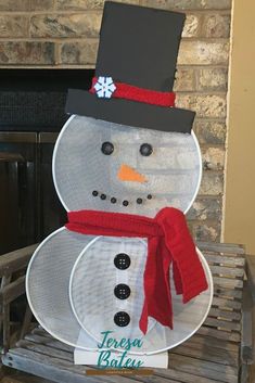 a snowman made out of mesh sitting on top of a wooden bench in front of a fireplace