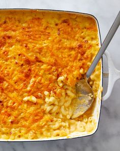 a casserole dish with macaroni and cheese in it on a marble table